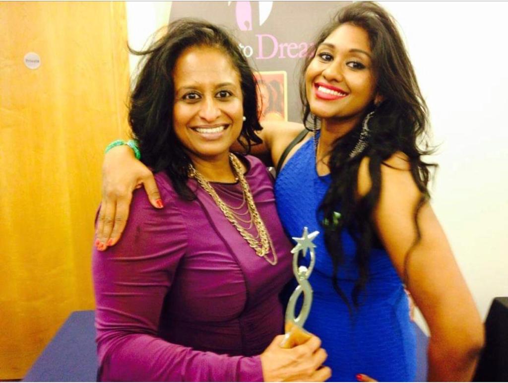Usha Oliver with a mentee celebrating an award